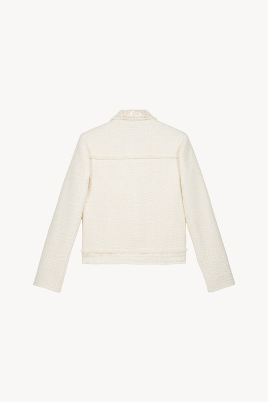 Veste en tweed blanc cassé avec sequins et boutons brodés avec une coupe droite structurée .