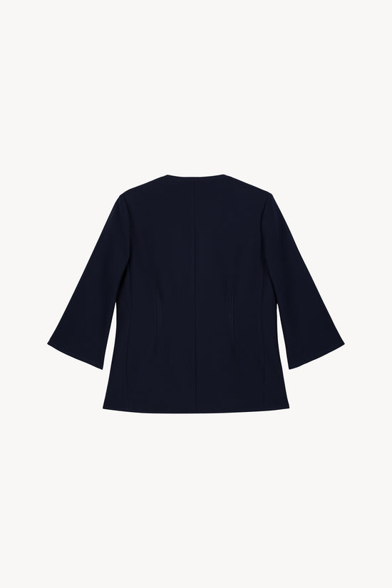 Veste bleu marine chic à manches 3/4 et boutons œillet métallisés.