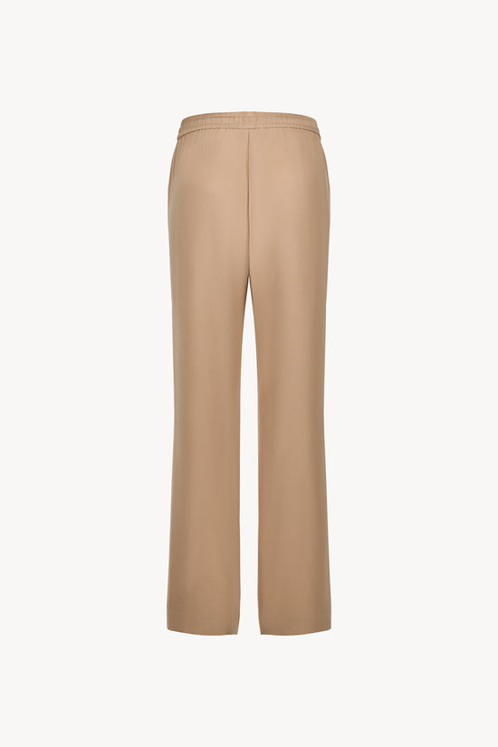Avec sa taille ajustable et  sa coupe droite , ce pantalon en soie fluide sublime la silhouette .