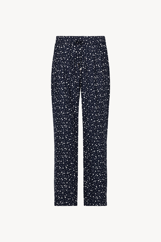 Pantalon marine à pois, coupe fluide et taille élastiquée, avec cordon de serrage métallisé .
