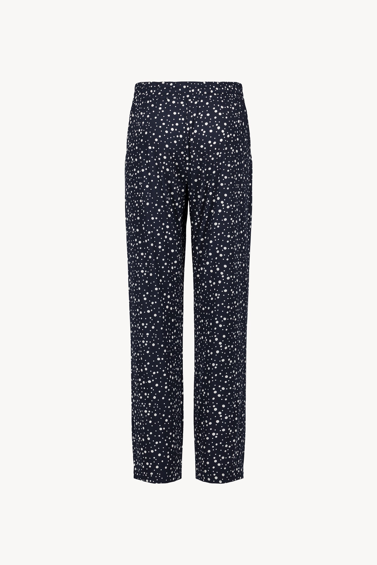 Ce pantalon marine à pois, à la coupe fluide et taille élastiquée