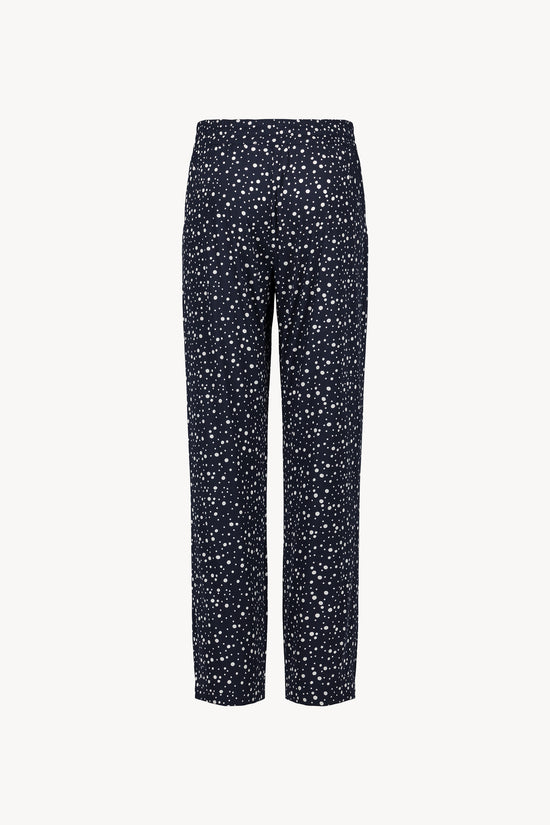 Ce pantalon marine à pois, à la coupe fluide et taille élastiquée